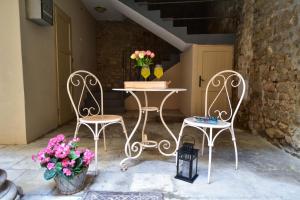 two chairs and a table with flowers on a patio at Zadar Sweet Studios in Zadar
