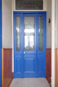 a blue door in a building with a window at Le quai Sud in Fécamp