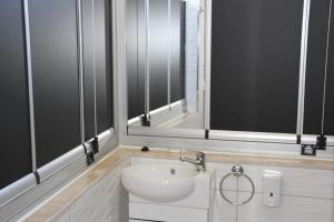 a bathroom with a white sink and a mirror at AELBİSTAN OTEL in Didim +22 photos
