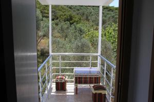 a room with a view of the forest from a balcony at AELBİSTAN OTEL in Didim