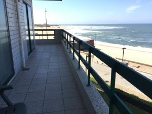 a balcony of a house with a view of the beach at Casa na Praia in Póvoa de Varzim