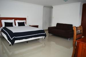 Rúm í herbergi á COLOMBIA-Hotel Hontibon