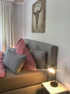 a living room with a couch with pillows on it at Landhaus Thome in Nideggen