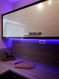 a large screen in a room with a wooden counter at Apartment Julia in Split