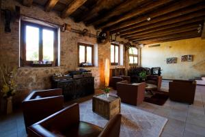 a living room with chairs and a table and windows at Hotel Moli De La Torre in Bigues i Riells