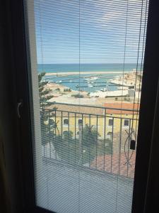 a window with a view of a city and the ocean at Residence Ducale in Rodi Garganico