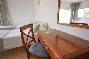 a bed room with a chair and a desk at Houm Nets - Adults Only in Playa de Palma