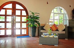 a living room with a couch and a table with books at Hotel Club Akumal Caribe in Akumal