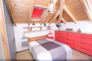 a bedroom with red cabinets and a bed in a attic at Bed N' Brot in Yerushalayim