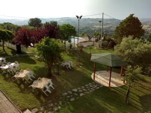 a group of tables and chairs in a garden at Residence Ristorante Baobab in Controguerra