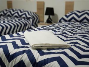 two blue and white beds with towels on them at Apartamento Completo Maravall Centro in Benidorm +14 photos