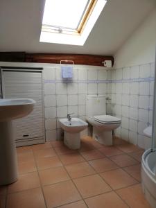 a bathroom with a sink and a toilet and a window at La Soffitta di Maria in La Spezia