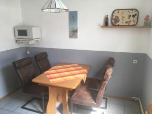 ein Tisch und Stühle mit einer Tischdecke drauf in der Unterkunft Ferienwohnungen im Gästehaus Sieberns in Carolinensiel