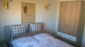 a small bedroom with a bed and a cabinet at Ferienwohnung Kück-Rathausstrasse in Hahnenklee-Bockswiese