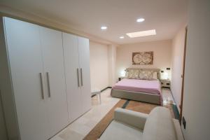 a bedroom with a bed and a cabinet and a couch at Al Vecchio Fontanile in Lesina