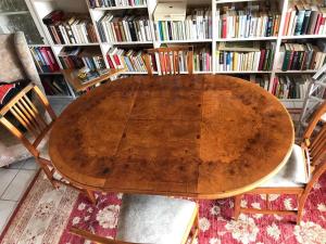 a wooden table and two chairs in a library at Ferienwohnung Kück-Rathausstrasse in Hahnenklee-Bockswiese +5 photos