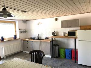 a kitchen with a sink and a stove top oven at Agroturystyka Zacisze in Maciejowiec