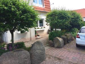 a garden with rocks in front of a house at Wave in Heiligenhafen