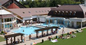 a group of people standing around a swimming pool at Geri Apartman in Mezőkövesd