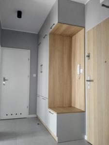 a room with a closet with a wooden cabinet at Caroline Street nine in Katowice