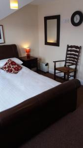 ブラックプールにあるdelamere holiday apartmentsのベッドルーム1室(ベッド1台、椅子、鏡付)