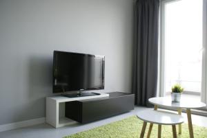 a living room with a flat screen tv on a cabinet at Caroline Street nine in Katowice