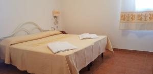 a table with two white napkins on top of it at Residence Spiaggia Bianca in Golfo Aranci