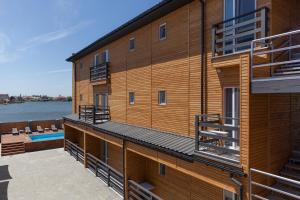a building with a deck and a swimming pool at Villa Solomare in Zatoka