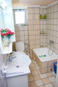 a bathroom with a tub and a toilet and a sink at Villa SteMa in Xirokámbion
