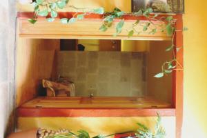 a wooden shelf with a mirror in a room at Hotel Plaza Mayor in Tlalpujahua de Rayón