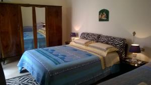 a bedroom with a bed and a mirror at B&BGalatina1 CIS in Galatina