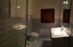 a bathroom with a toilet and a sink and a shower at Residence Spiaggia Bianca in Golfo Aranci