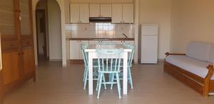 a kitchen with a table and chairs in a room at Residence Spiaggia Bianca in Golfo Aranci