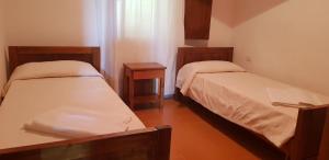 a room with two beds and a window at Residence Spiaggia Bianca in Golfo Aranci