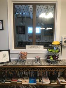 a window in a room with a shelf of books at Crescent Suites Hotel in Waltham