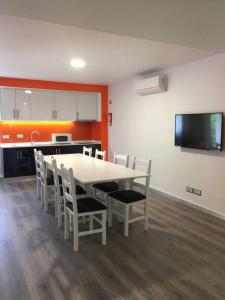a dining room with a white table and chairs at PinoyHouse Fatima in Fátima