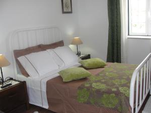 a bedroom with a bed with two pillows on it at Quinta do Belo-Ver Turismo de Habitacao in Belver +21 photos