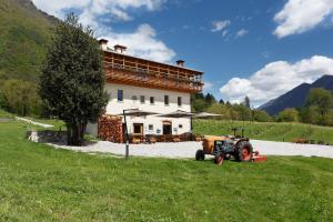 a tractor parked in front of a building at Agritur La Polentera in Storo