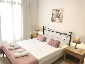 a bedroom with a bed with two pillows on it at Beautiful City Center Flat in Rhodes Town