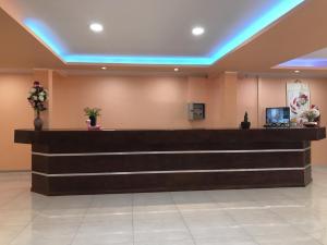 a hotel lobby with a reception desk and blue lights at Hotel Amayal in Puerto Iguazú