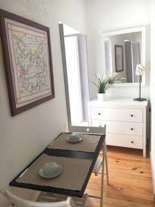 a dining room with a table and a dresser at Cantinho da Matriz in Viana do Castelo