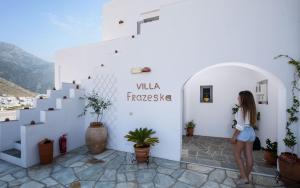 a woman standing in front of a white building at Villa Frazeska in Kamares