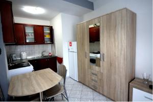 a small kitchen with a table and a wooden cabinet at Dimitris Flat in Neoi Epivates +9 photos