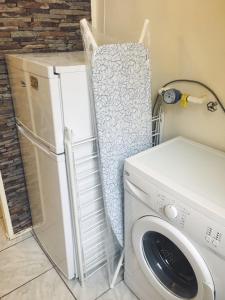 a laundry room with a washing machine and a washer at Adrienn apartment in Budapest