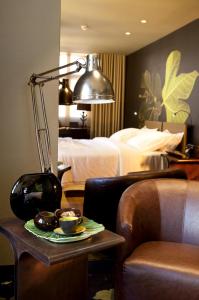 a hotel room with a bed and a table with a plate of food at Figueira by The Beautique Hotels & Spa in Lisbon