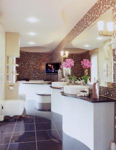 a bathroom with two sinks and two toilets at Hotel Alhar in Lubliniec