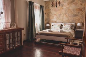 a bedroom with a bed and a stone wall at La Dama del Mar in Telde +51 photos