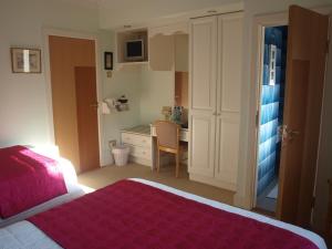 a bedroom with a bed and a desk in it at Shelmalier House in Athlone