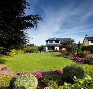 a house with a large yard with flowers at Shelmalier House in Athlone