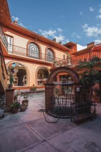 a large building with an archway in a courtyard at La Cupula B&B Teotitlan in Teotitlán del Valle
